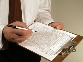 business man fills out a tax form